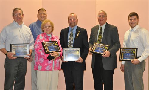 Hall of Achievement winners pose in a group with their plaques